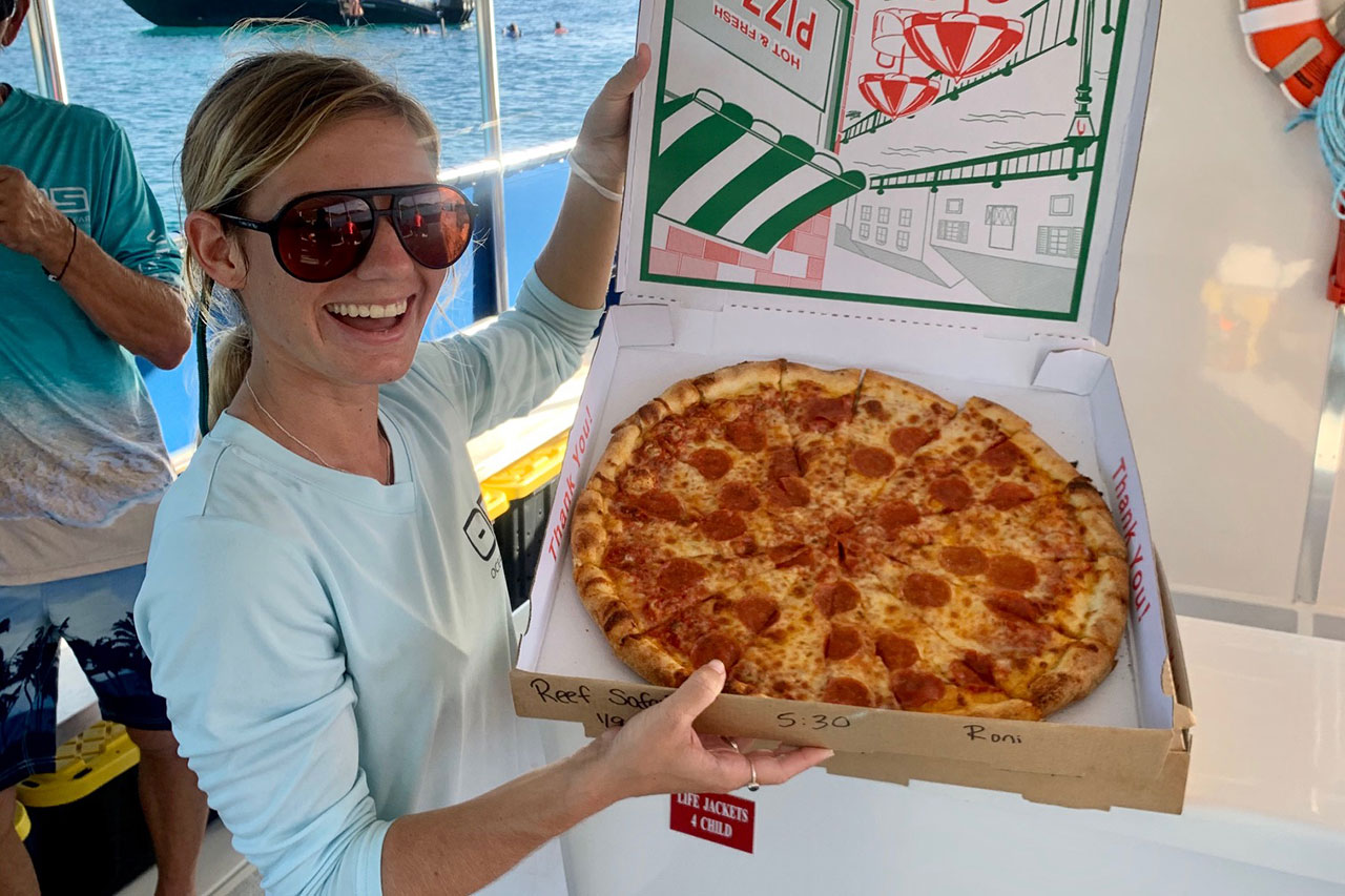 sunset pizza pi cruise woman with pizza